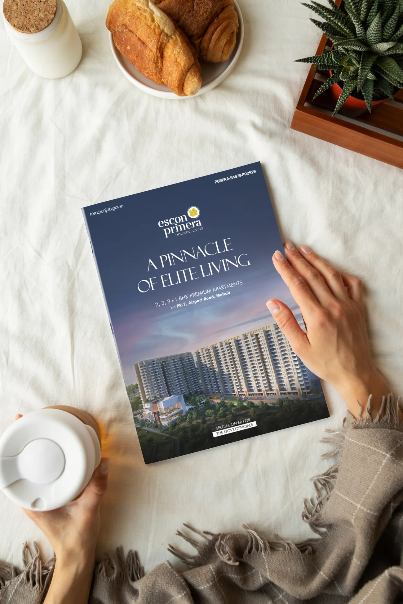 Escon Primera brochure held above a table